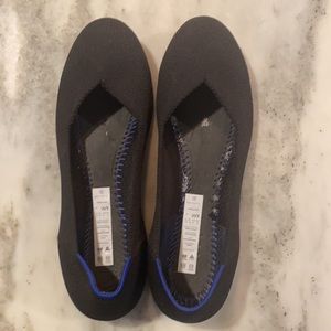 Rothy’s “The Flat” in classic black, size 9.